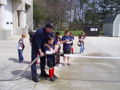 The Troop Holds the Fire Hose